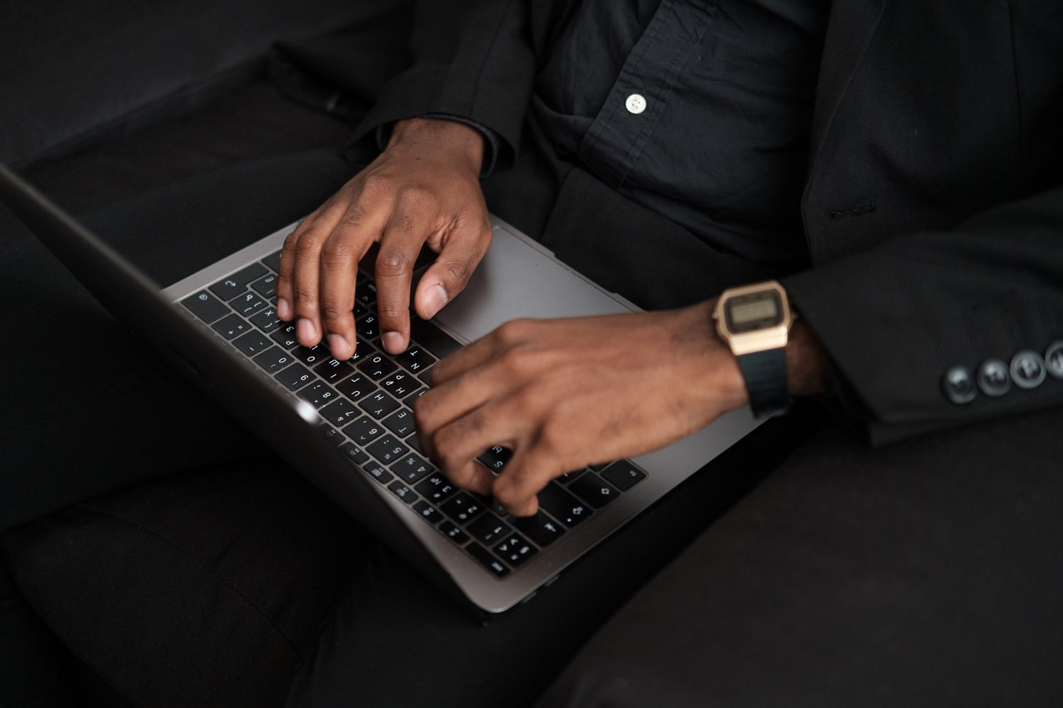 Man Typing on Laptop